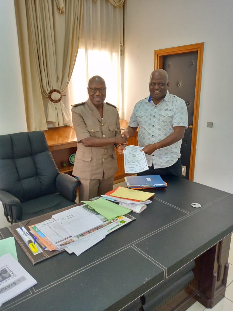 Le préfet du district autonome de Yamoussoukro, Brou Kouamé, remettant le document de l'acquisition du terrain à l'émissaire de l'Adekash